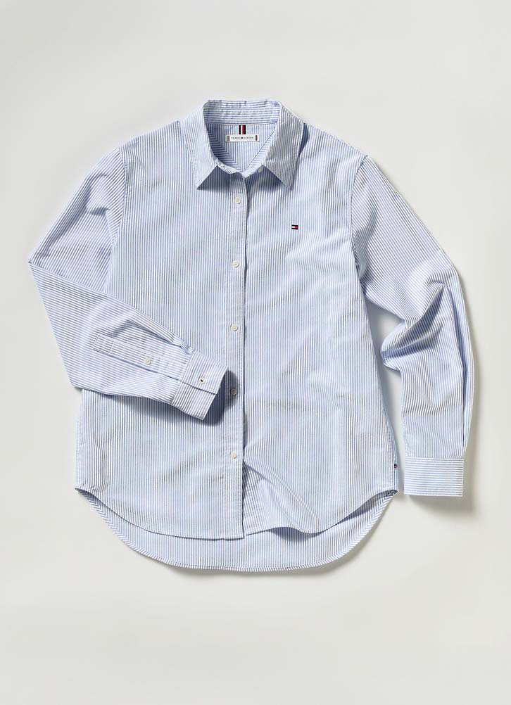 Light blue Tommy Hilfiger button-down shirt displayed on a hanger