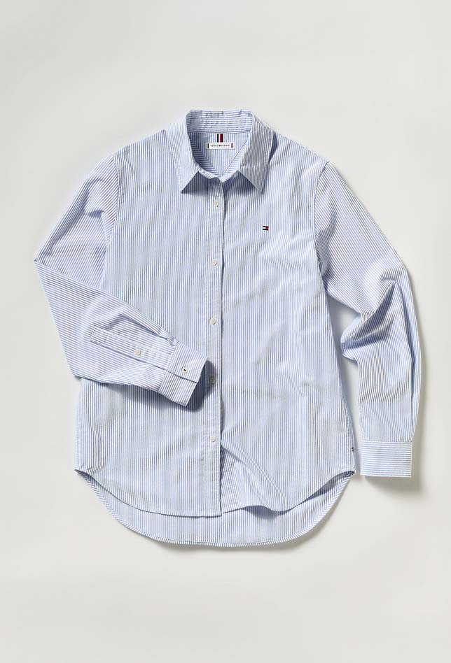 Light blue Tommy Hilfiger button-down shirt displayed on a hanger