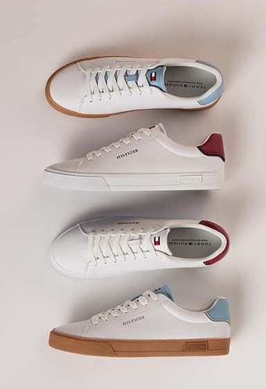 White and neutral Tommy Hilfiger sneakers displayed side by side on a light background, highlighting different sole and lace details.