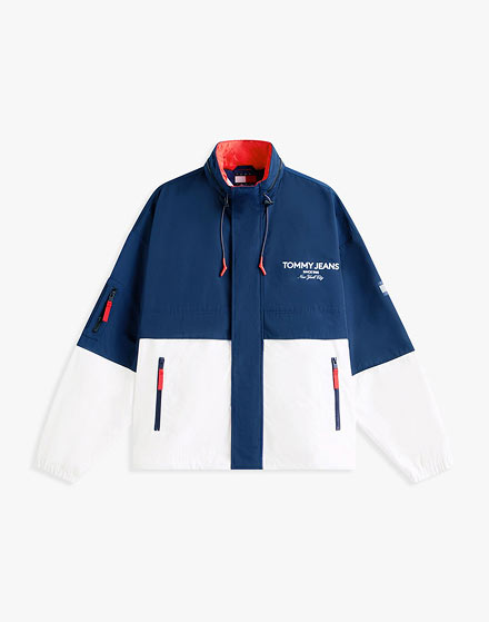 Red Tommy Jeans puffer jacket with a hood and small flag logo, photographed on a white background.