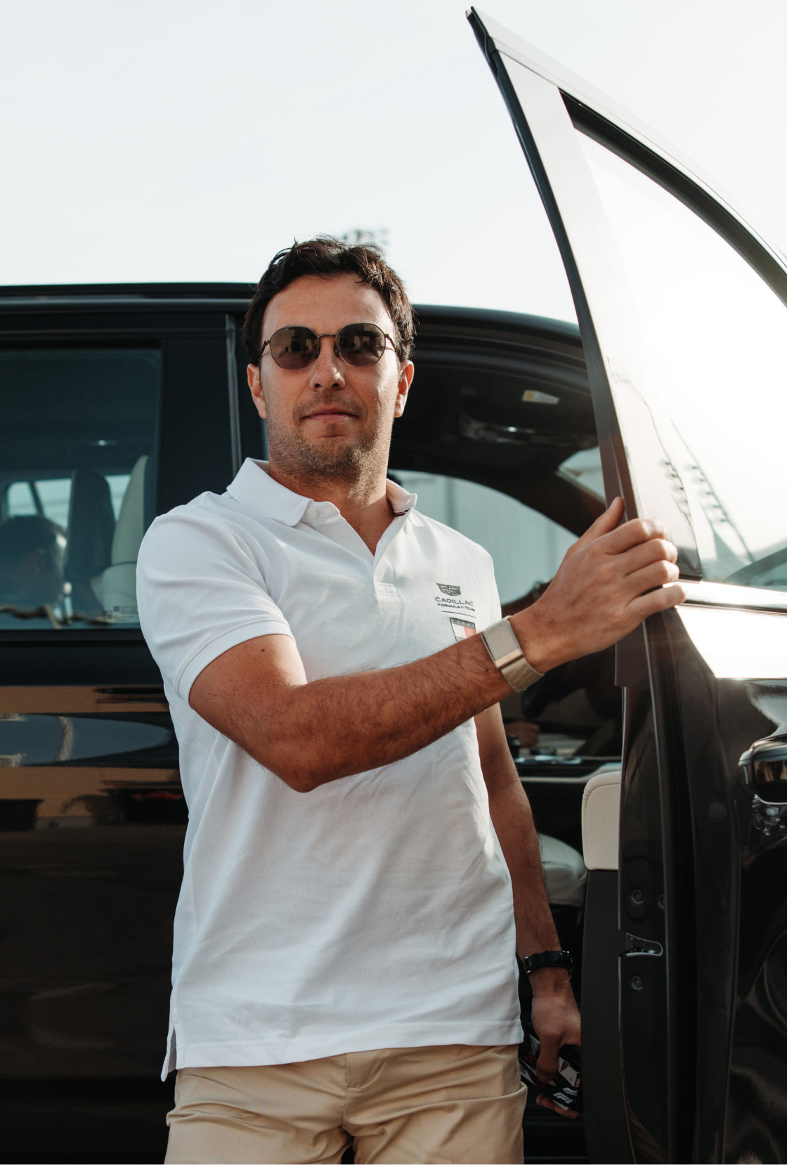 Checo Pérez wearing Tommy Hilfiger x Cadillac clothing.
