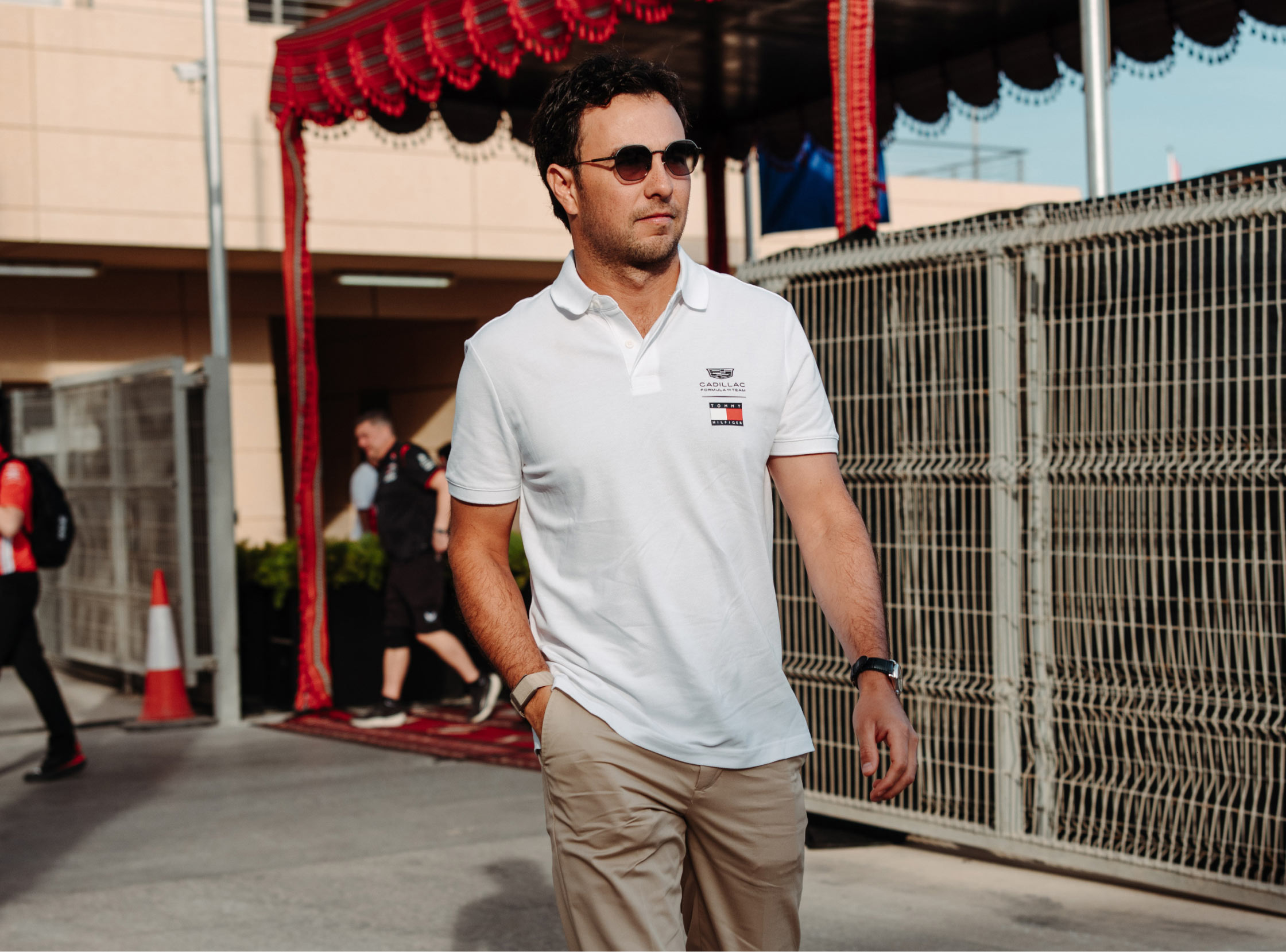 Checo Pérez wearing Tommy Hilfiger x Cadillac clothing.