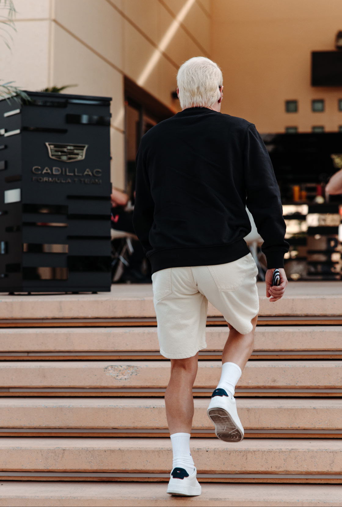 Valtteri Bottas wearing Tommy Hilfiger x Cadillac clothing.