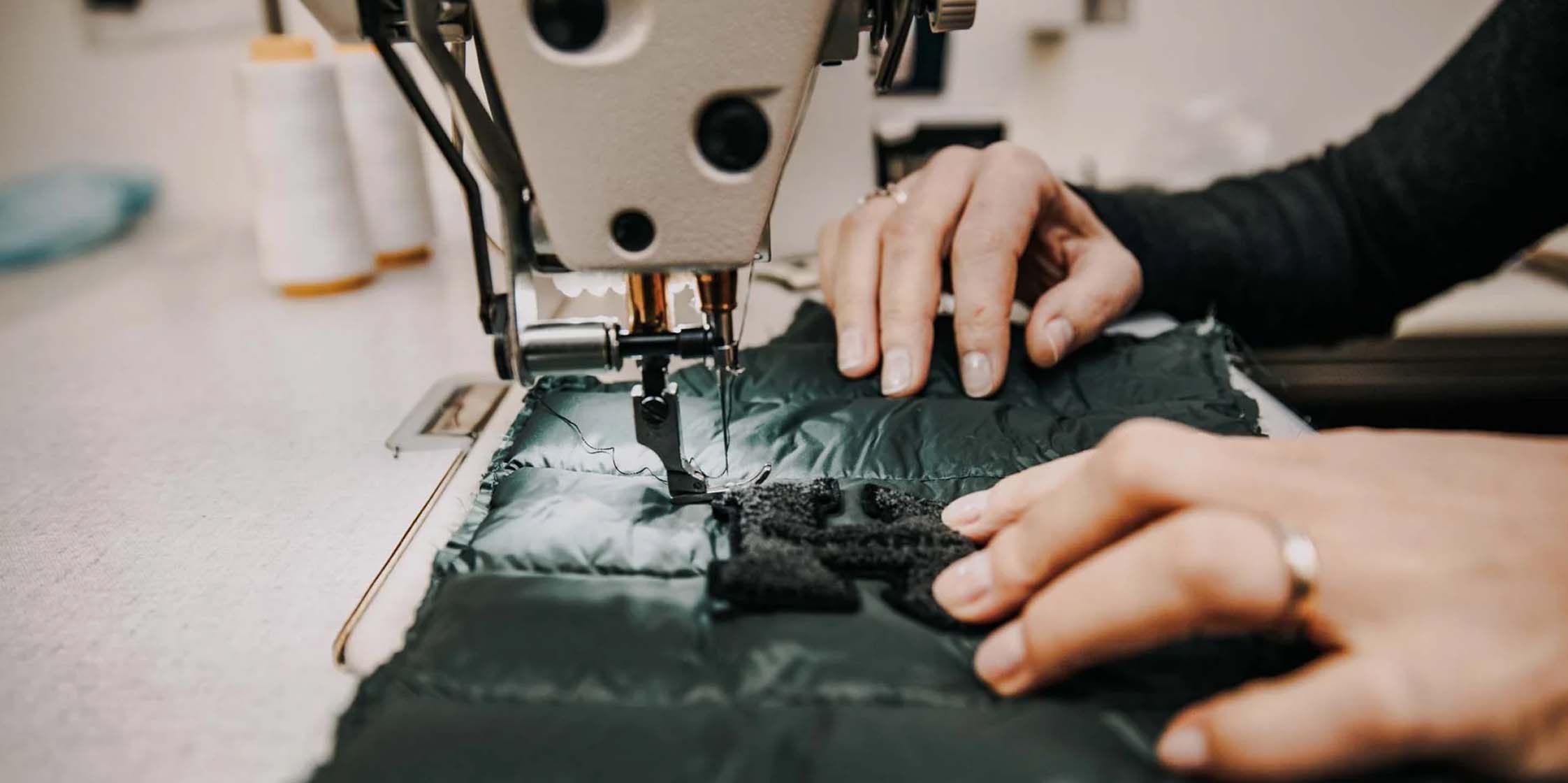 A person stitching clothing.