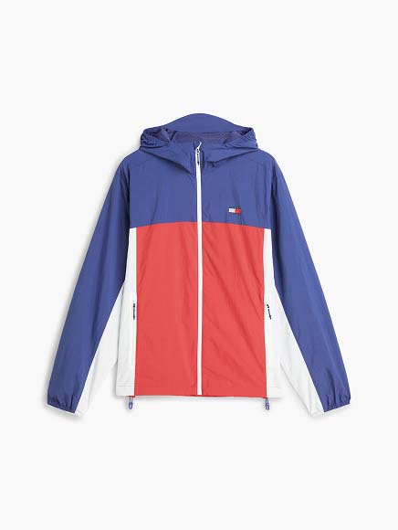 Red Tommy Jeans puffer jacket with a hood and small flag logo, photographed on a white background.