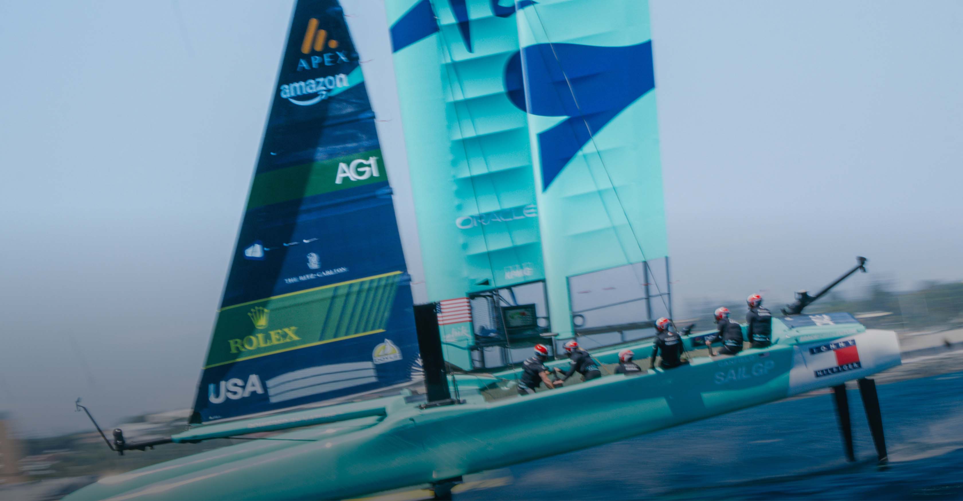 USA SailGP team racing catamaran on open water with overlay text reading, 'Born to the water, built for the city.'