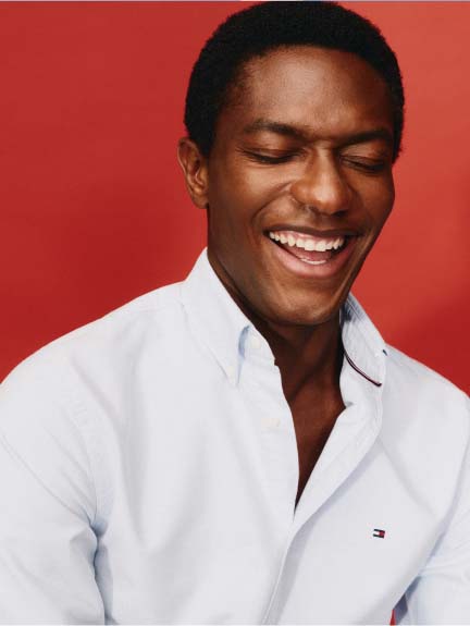 A male model wearing a Tommy Hilfiger Shirt