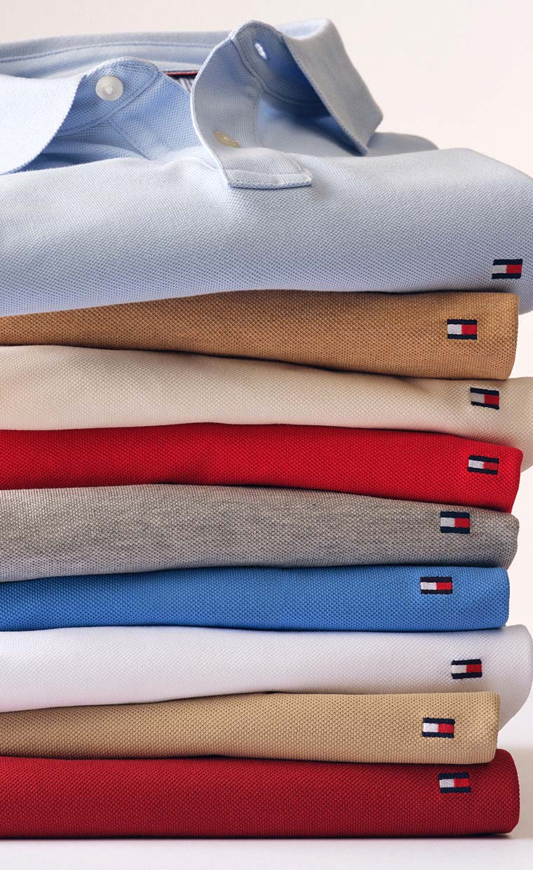 Stacked Tommy Hilfiger polosin pastel and neutral colors.