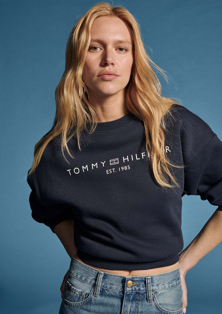Model sitting wearing a full denim Tommy Hilfiger outfit