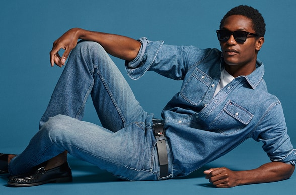 Model sitting wearing a full denim Tommy Hilfiger outfit