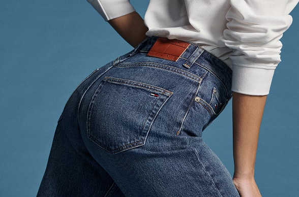 Model sitting wearing a full denim Tommy Hilfiger outfit