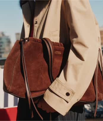 Close-up of a Tommy Hilfiger brown leather handbag.