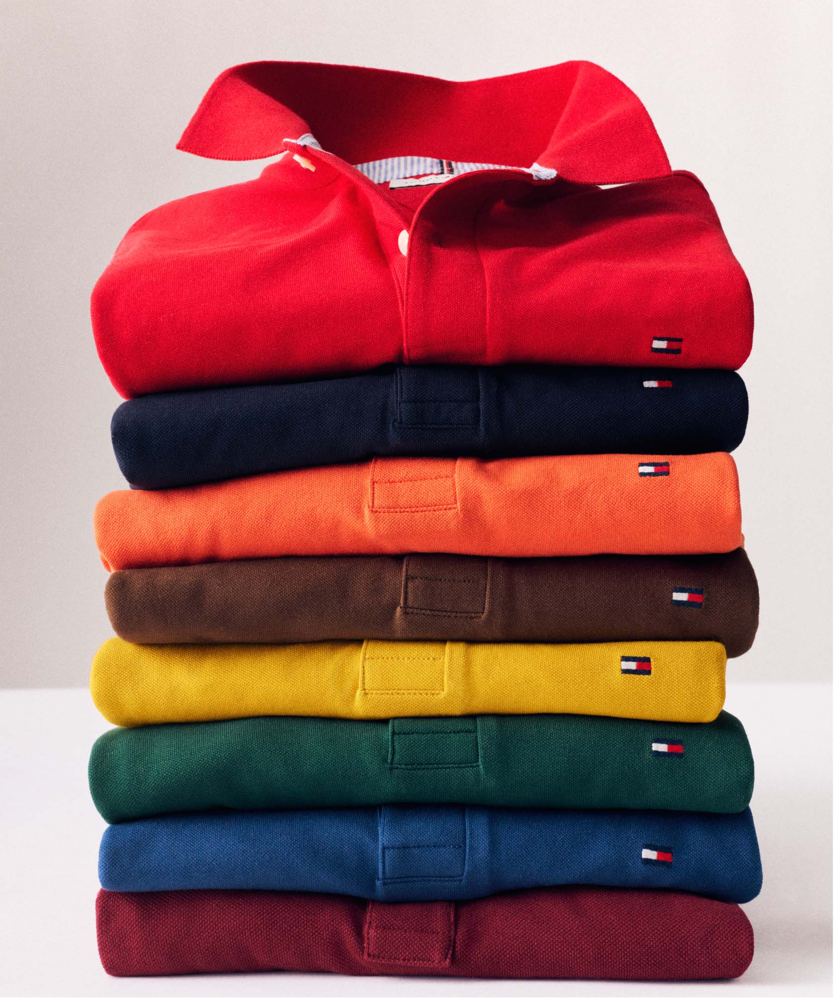 A stack of colorful folded Tommy Hilfiger polos.