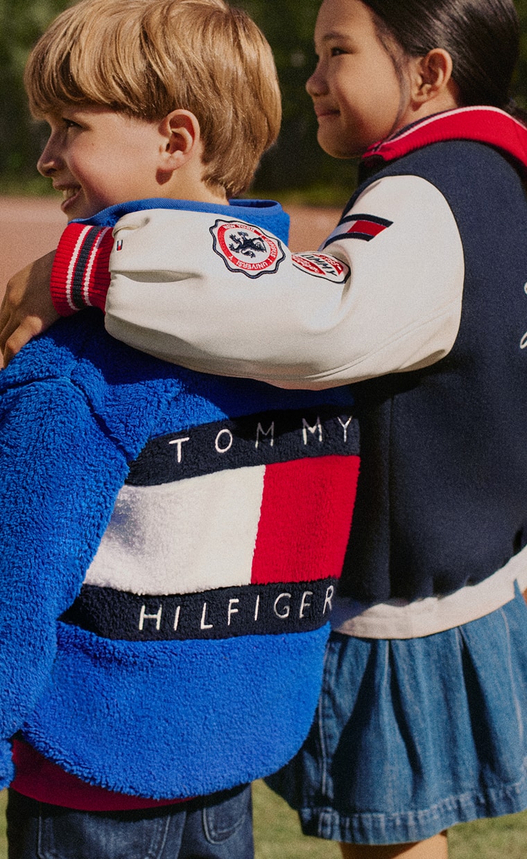 Two kids wearing a Tommy Hilfiger outfits.