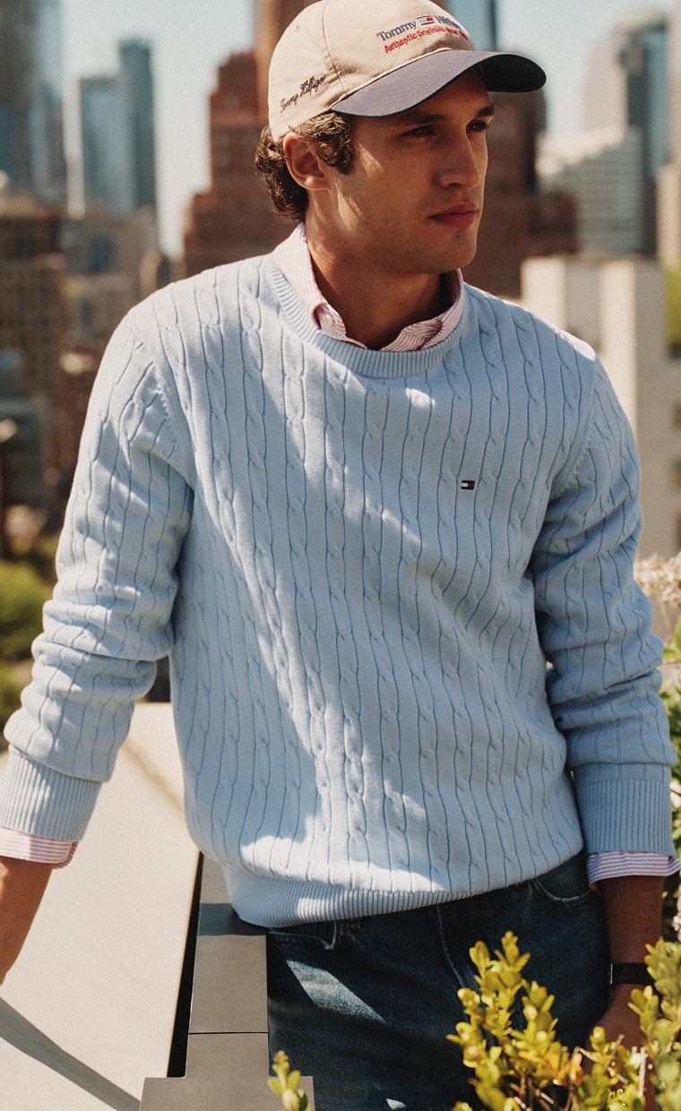 Model wearing a blue Tommy hilfiger sweater.