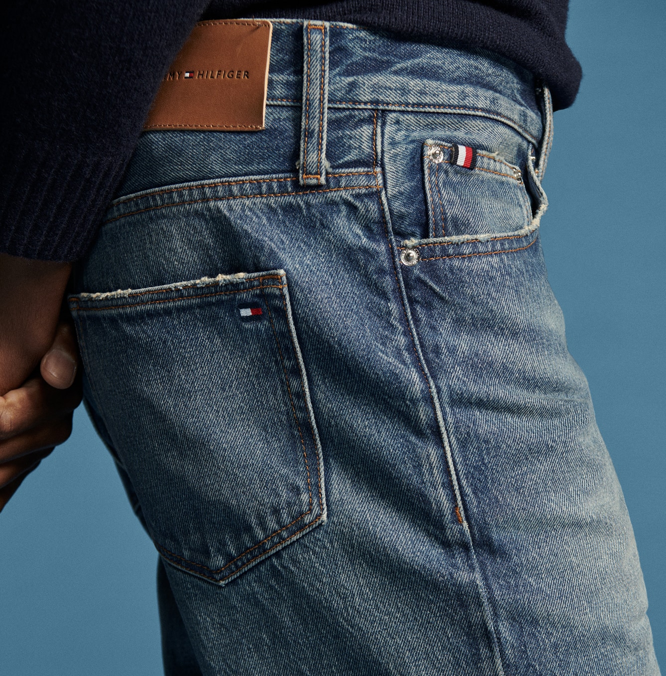Models in denim wearing Tommy Hilfiger.