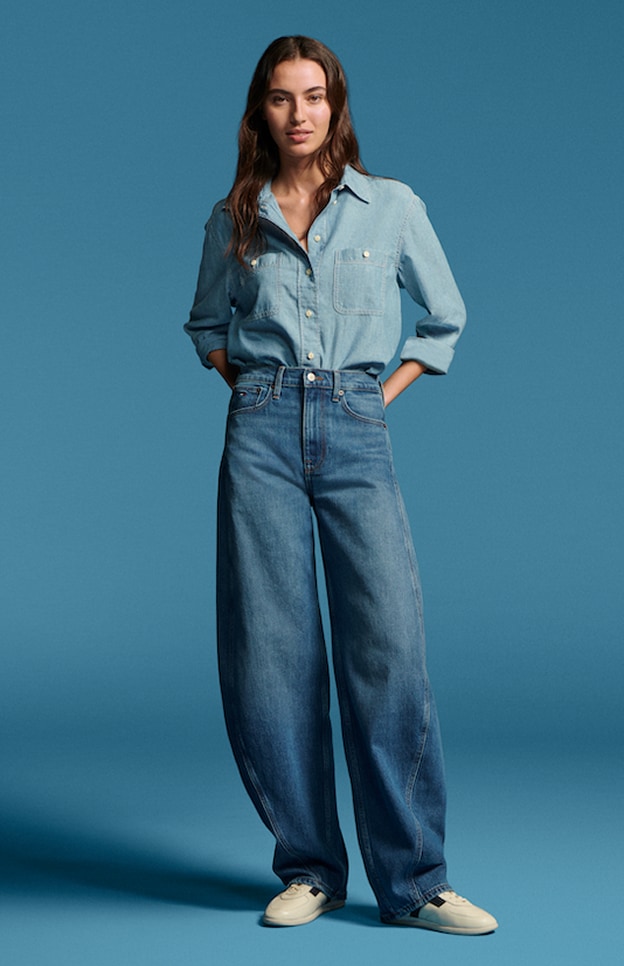 Model in denim wearing Tommy Hilfiger.