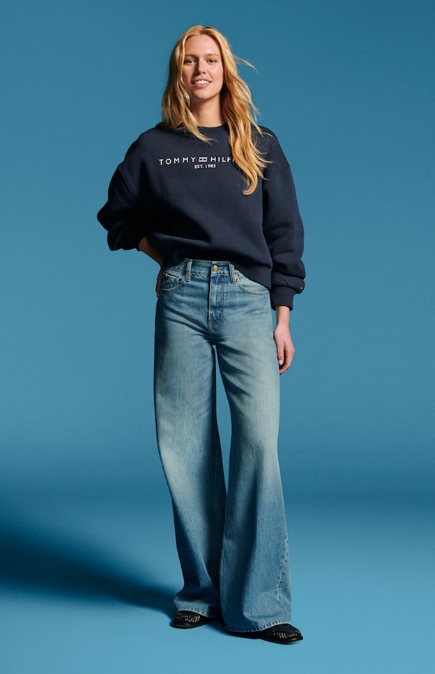 Model in denim wearing Tommy Hilfiger.