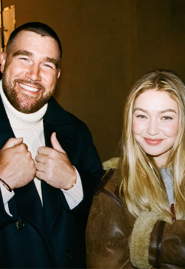 Travis Kelce and Gigi Hadid wearing Tommy Hilfiger jackets.