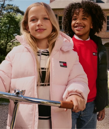 Two kids wearing Tommy Hilfiger outfits.