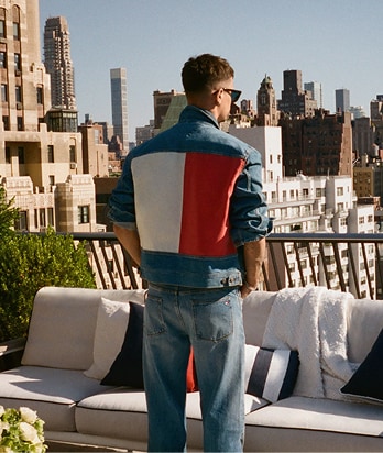 Back of a model wearing a Tommy Jeans denim jacket.