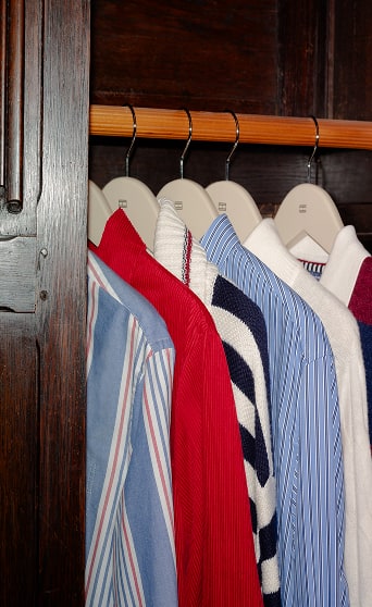 Tommy Hilfiger Shirts hanging on a rack,