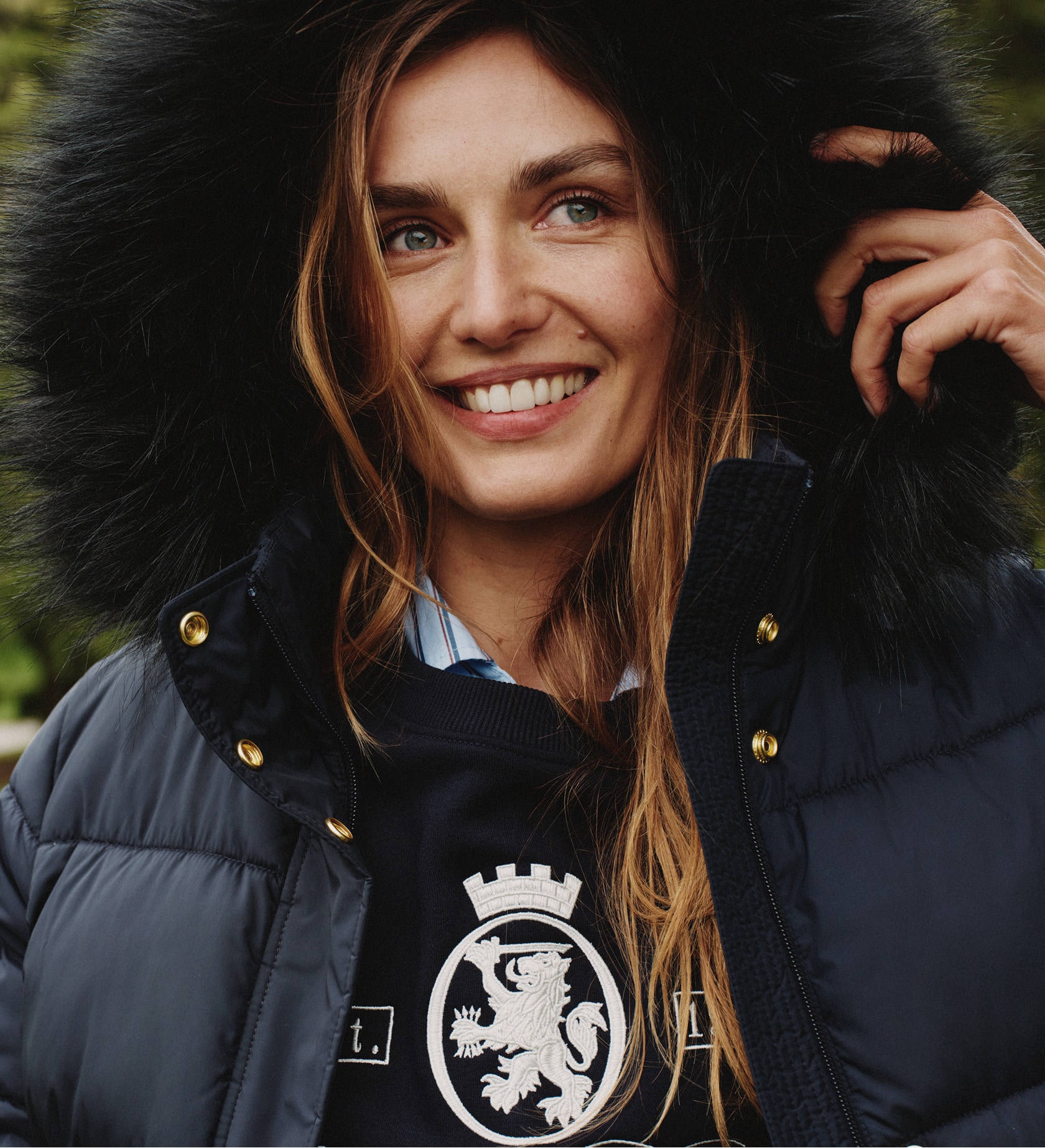 Model wearing a Tommy Hilfiger red quilted puffer jacket.