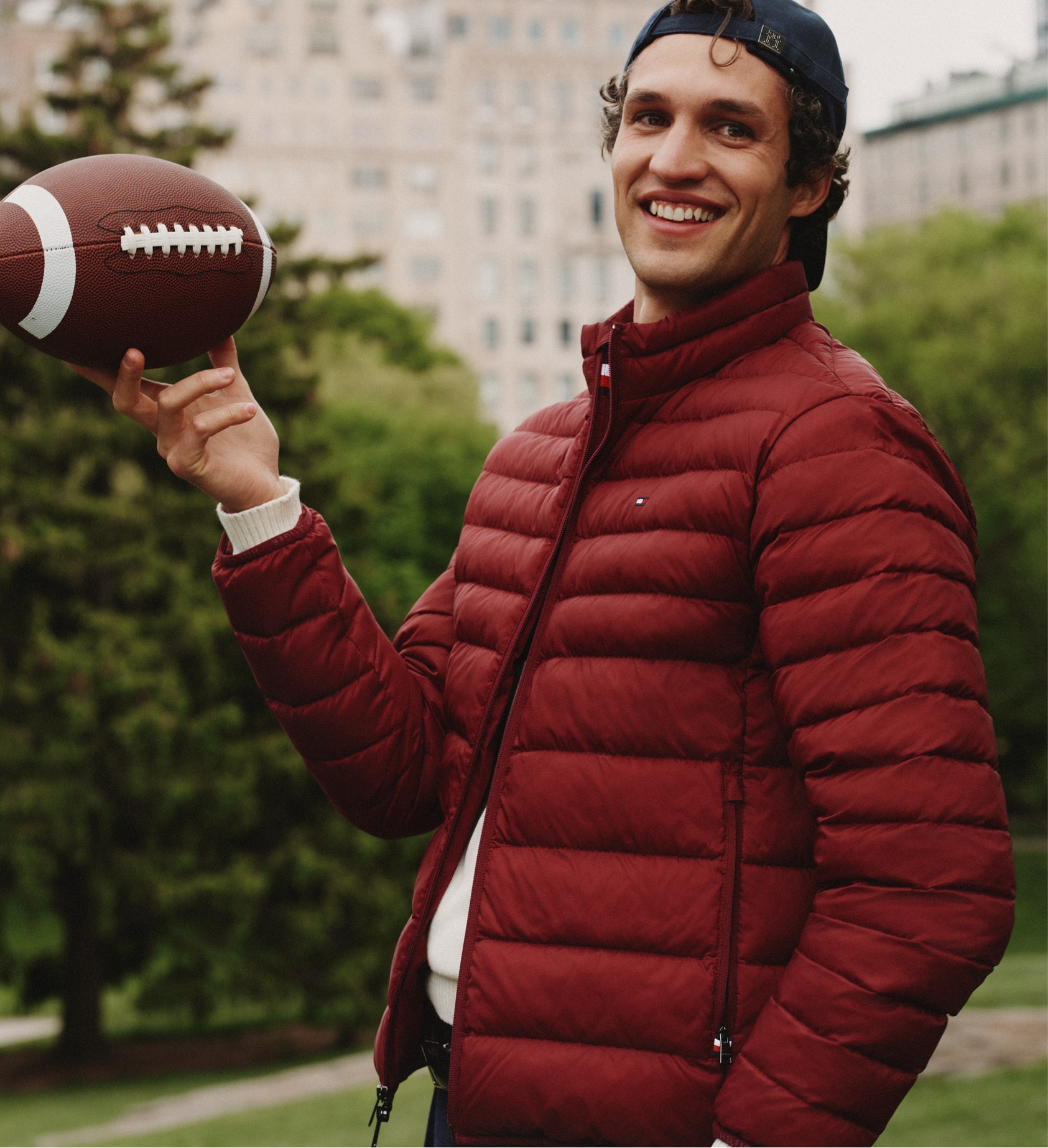 Model  wearing a Tommy Hilfiger navy puffer coat.