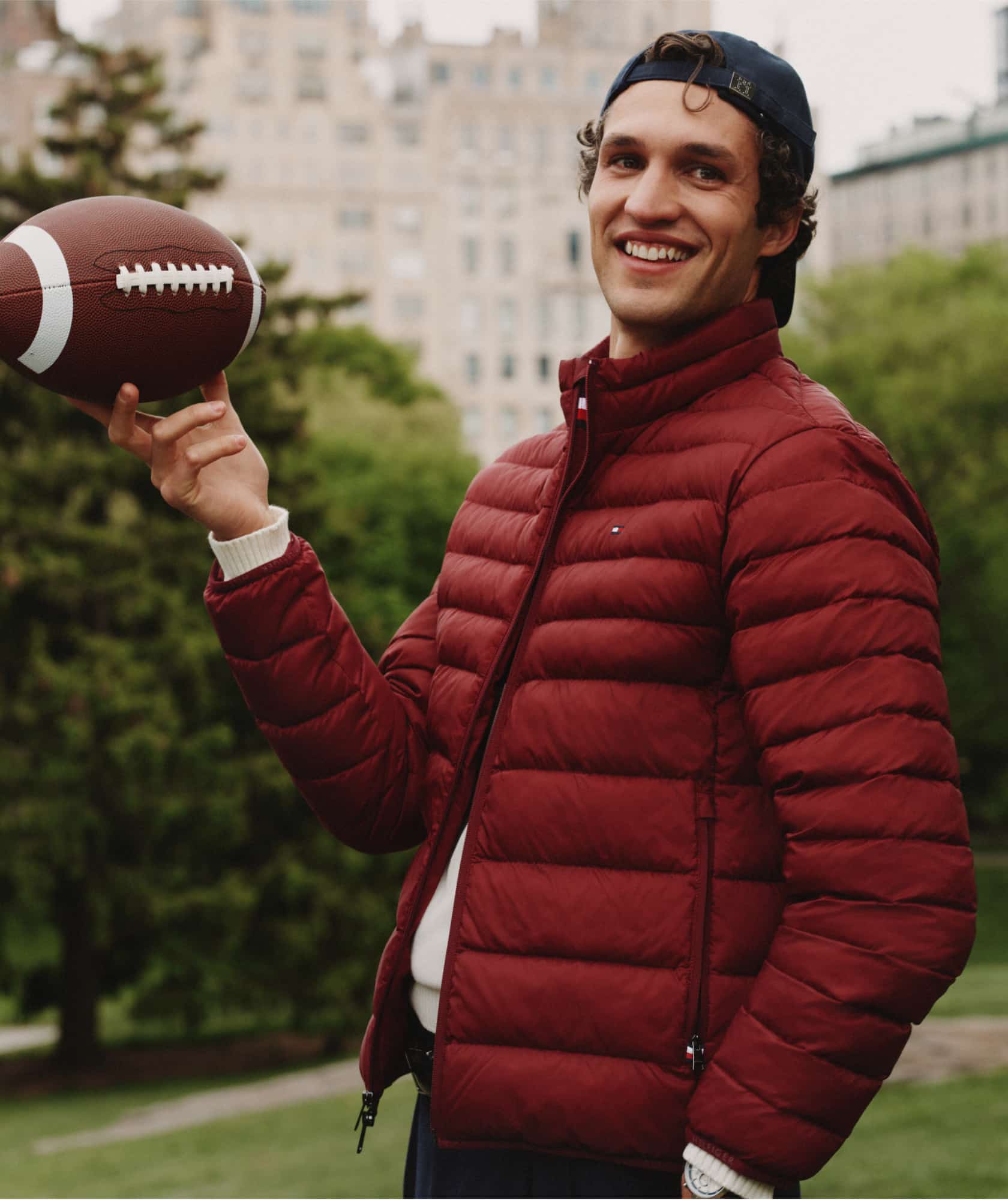 Model wearing a Tommy Hilfiger navy puffer coat.