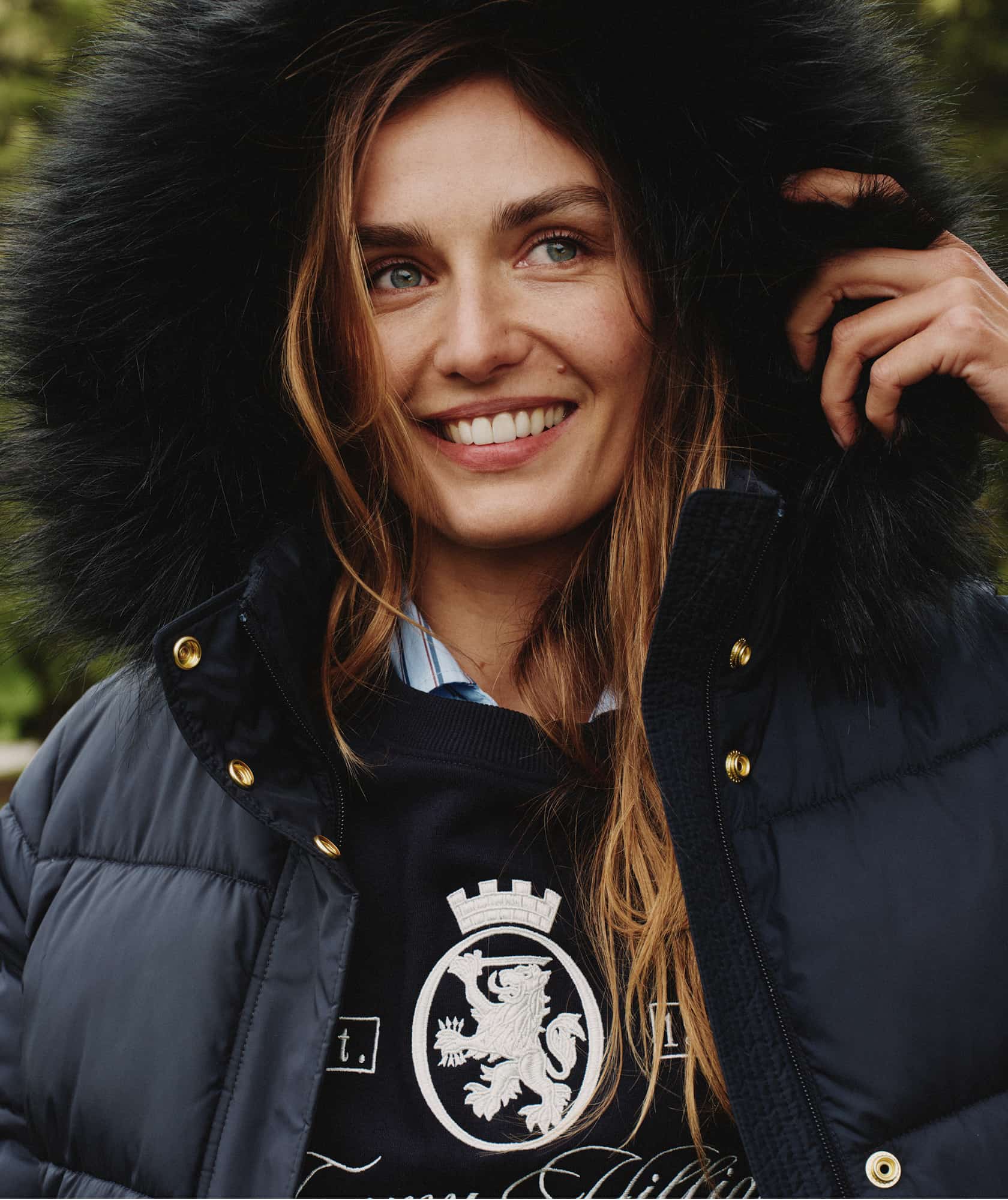 Model wearing a Tommy Hilfiger red quilted puffer jacket.