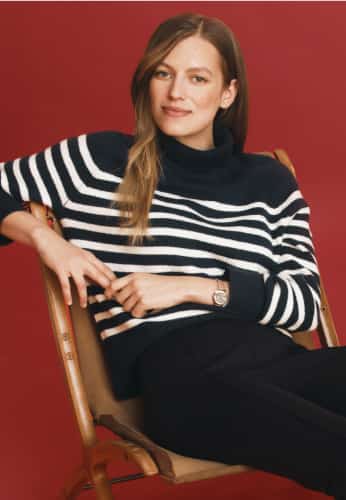 Model wearing Tommy Hilfiger striped sweater.