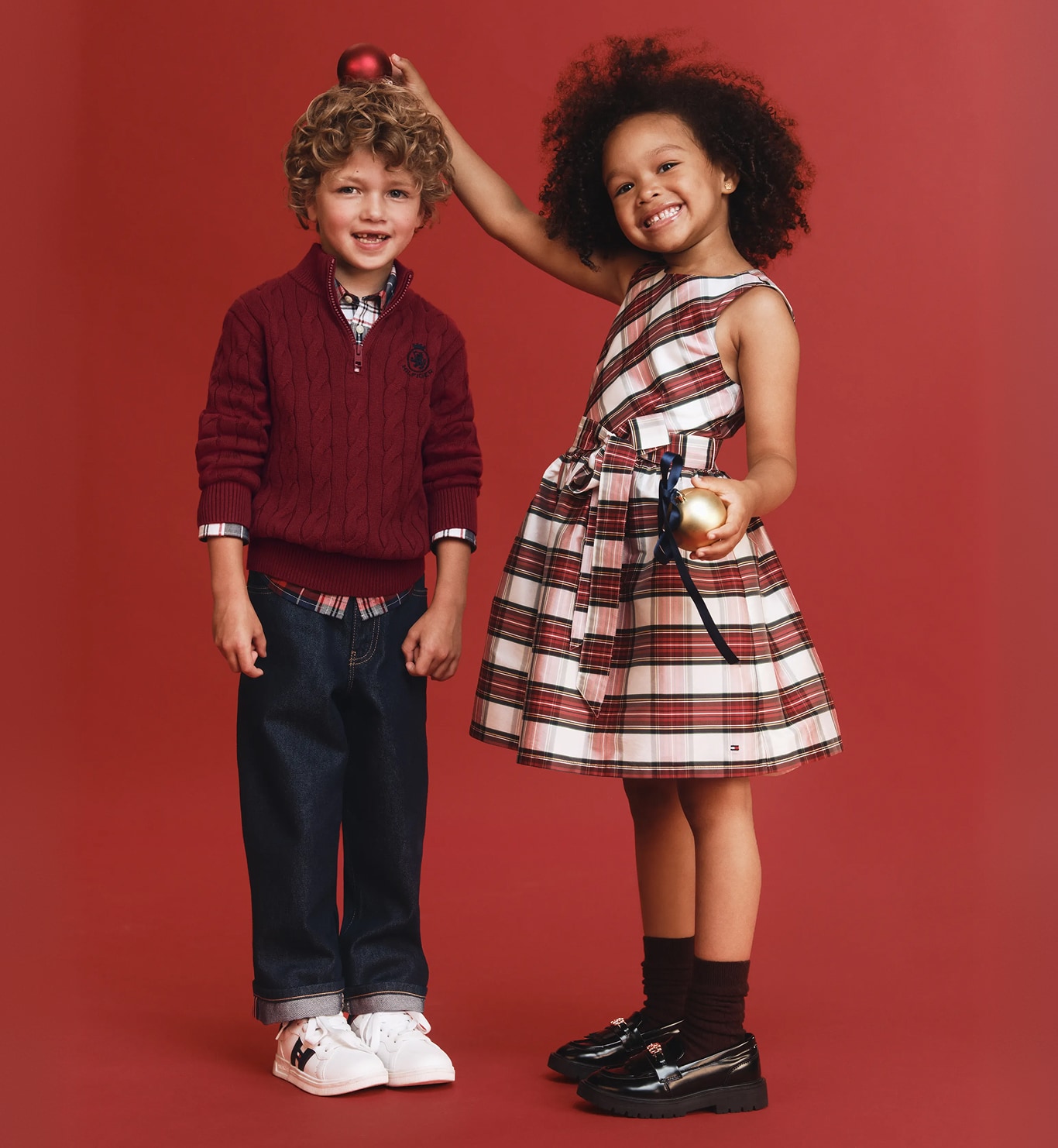 Two kids wearing Tommy Hilfiger outfit.