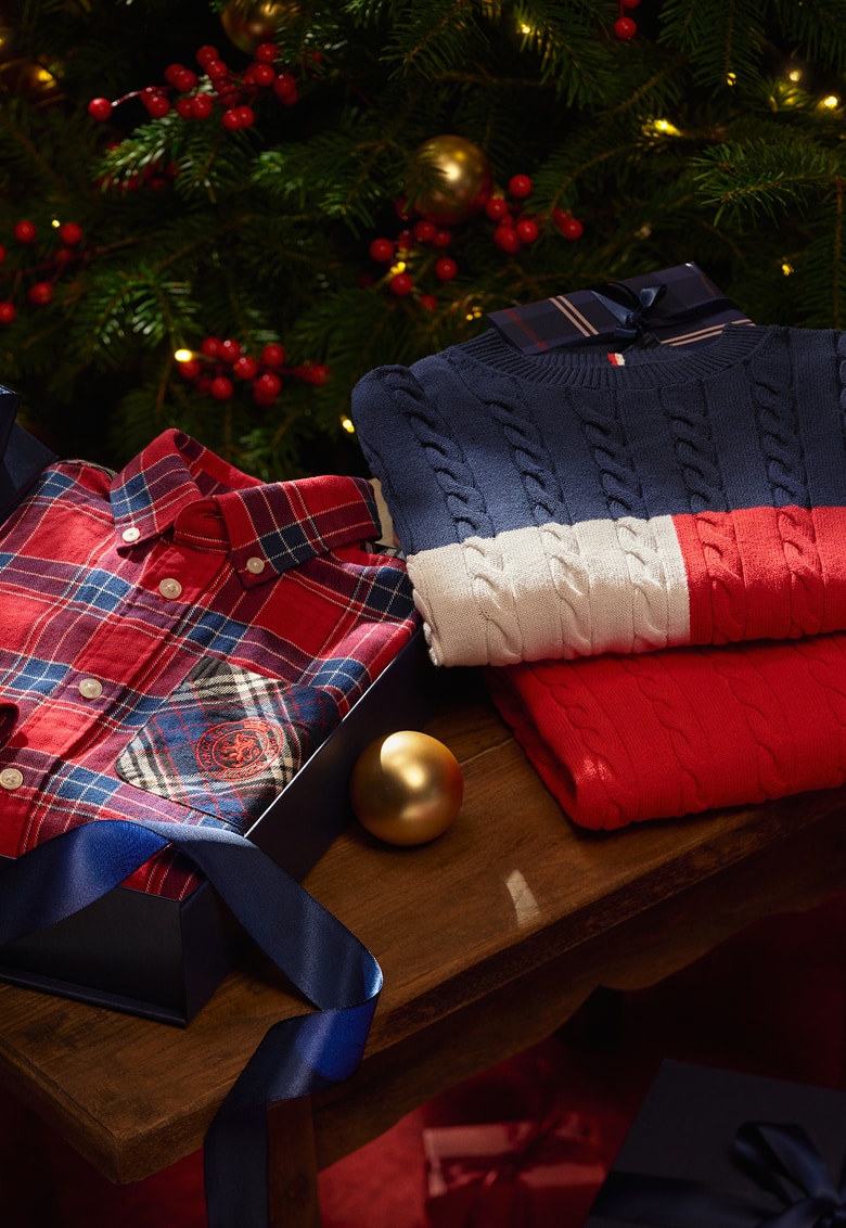 A stack of folded Tommy Hilfiger sweaters & tops.